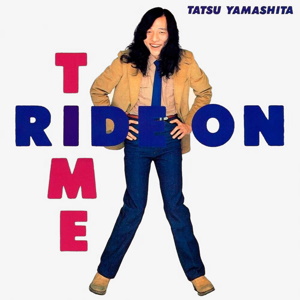The inner cover of Tatsuro Yamashita's Ride On Time. It shows him striking a pose and smiling as the text RIDE ON TIME, is shown crossed together, sort of like a crossword.